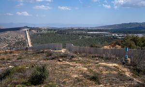 Concrete T-walls erected by the Israel Defense Forces near Yaroun, south Lebanon, crossing the Blue Line and rendering over 4,000 square metres of Lebanese territory inaccessible. A blue barrel marks the Blue Line.