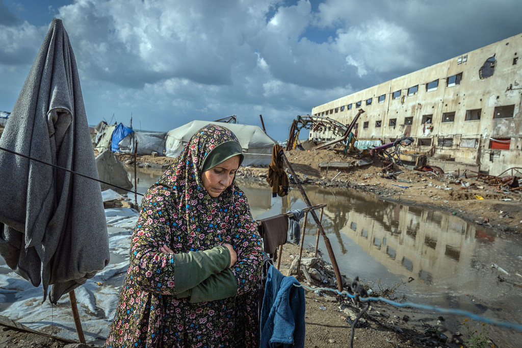 À Gaza, une femme se tient devant sa tente inondée, après le débordement d'un système d'égouts voisin dû aux fortes pluies.