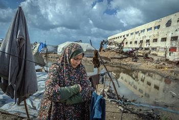 A woman in Gaza stands outside her tent, which was flooded after a sewage system nearby overflooded due to heavy rain. 