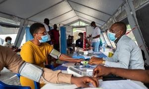 During the height of the COVID pandemic in November 2021, patients at a hospital in Kinshasa, the capital of the Democratic Republic of Congo prepare to receive a vaccine.