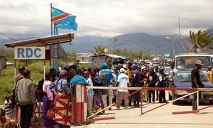 People fleeing violence in eastern DR Congo's Bukavu area, wait to cross the Gatumba border post into Burundi.