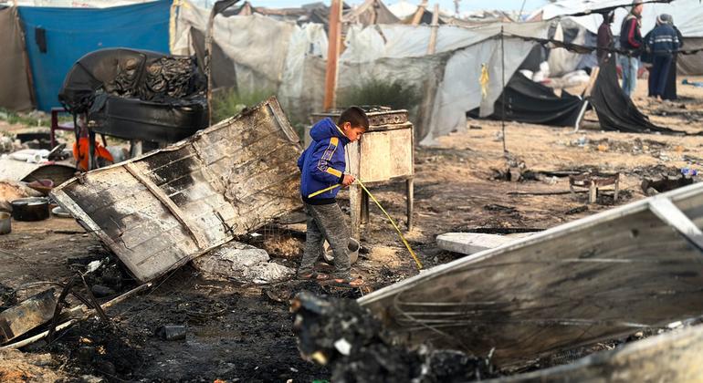 Un niño busca entre los restos de las posesiones de su familia tras la reanudación de los ataques aéreos en Gaza.
