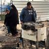 Members of a family in Gaza looks at their destroyed home.