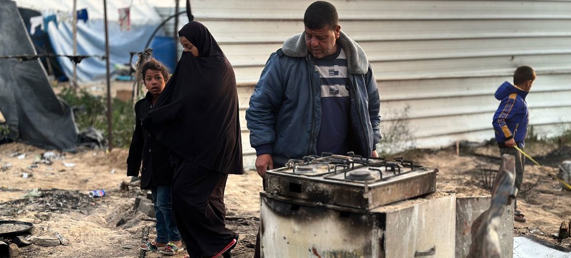 Members of a family in Gaza looks at their destroyed home. Members of a family in Gaza looks at their destroyed home.