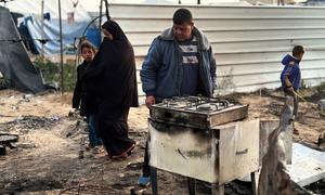Members of a family in Gaza looks at their destroyed home.