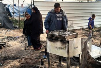 Les membres d'une famille à Gaza, devant les décombres de leur maison.