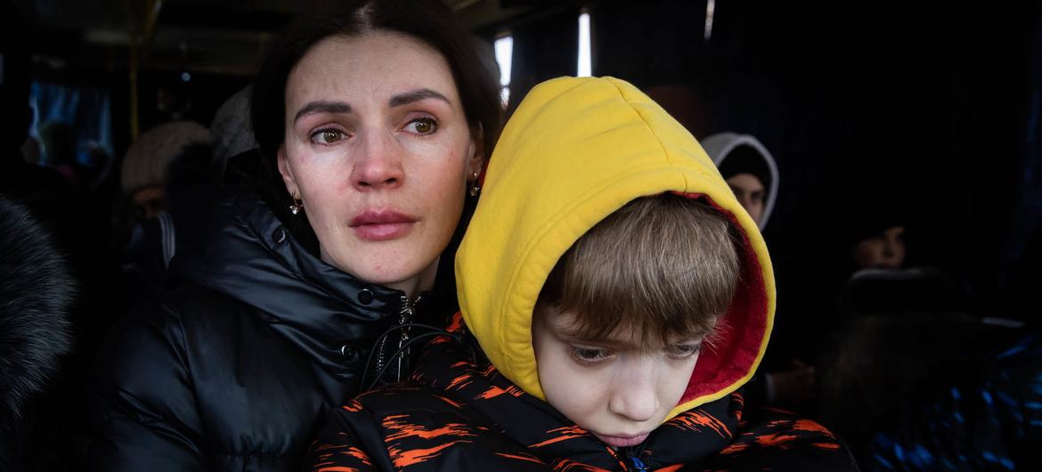 A mother and her son wait to be evacuated  from the besieged city of Mikolayiv in Ukraine in March 2022.