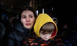 A mother and her son wait to be evacuated  from the besieged city of Mikolayiv in Ukraine in March 2022.