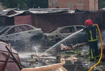 In Poltava, a city in central Ukraine, emergency service personnel work to douse debris left smoldering after an attack.