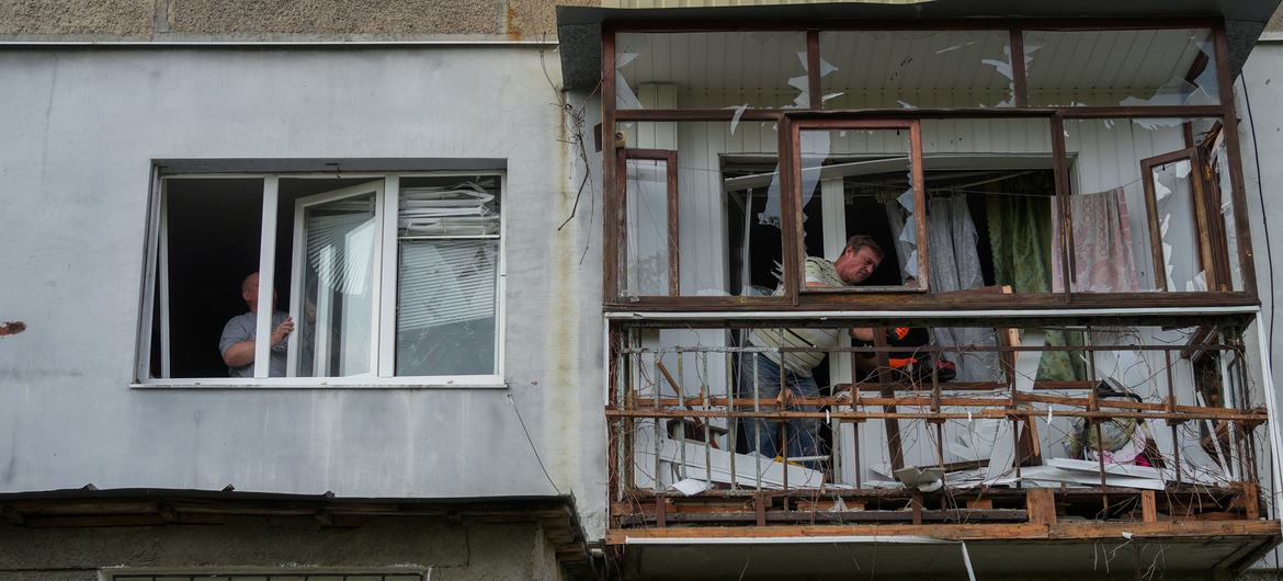 Men work at an apartment building in Poltava, a city in central Ukraine,  that was damaged in an attack.