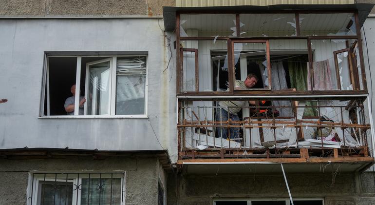 Men work at an apartment building in Poltava, a city in central Ukraine,  that was damaged in an attack.