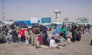 Afghan returnees from Iran gather at the Islam-Border, near Herat in western Afghanistan.