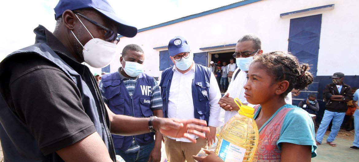 Issa Sanogo, UN Resident Coordinator successful  Madagascar, meets a young miss  who had received nutrient  aid.