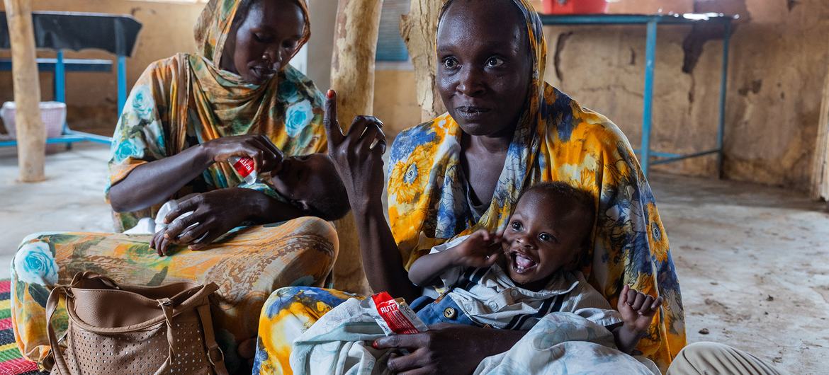 Mothers feed their malnourished children at a clinic in Jebel Awlia, south of the Sudanese capital, Khartoum.