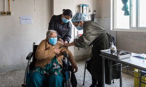 An elderly woman receives her COVID-19 vaccination at a hospital in Kathmandu, Nepal.