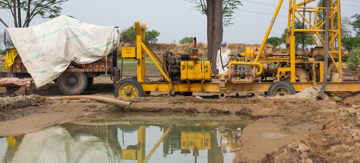 Farmers in Punjab, India are borewell drilling machines to access water.