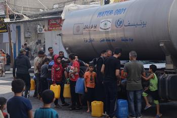 Drinking water is distributed to residents and displaced people in Rafah in the south of the Gaza strip.