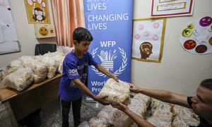 A boy collects bread from WFP, at a shelter in Gaza.