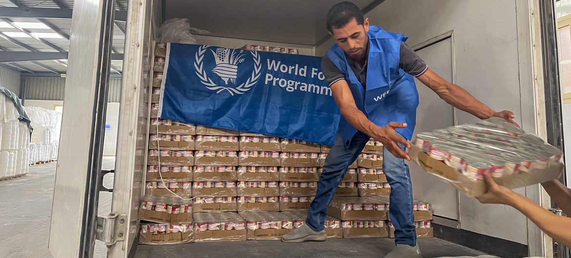 A worker unloads ready-to-eat rations from a truck close to Alexandria, Egypt, in preparation for delivery to Gaza.