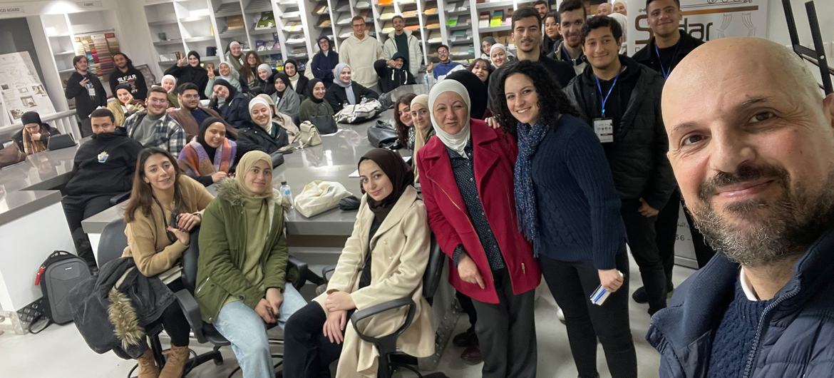 Omar Abdallat takes a selfie with the participants of one of his cartoon workshops.