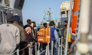 UN teams provide medical assistance to migrants who are disembarking in Abusita port in Tripoli, Libya.