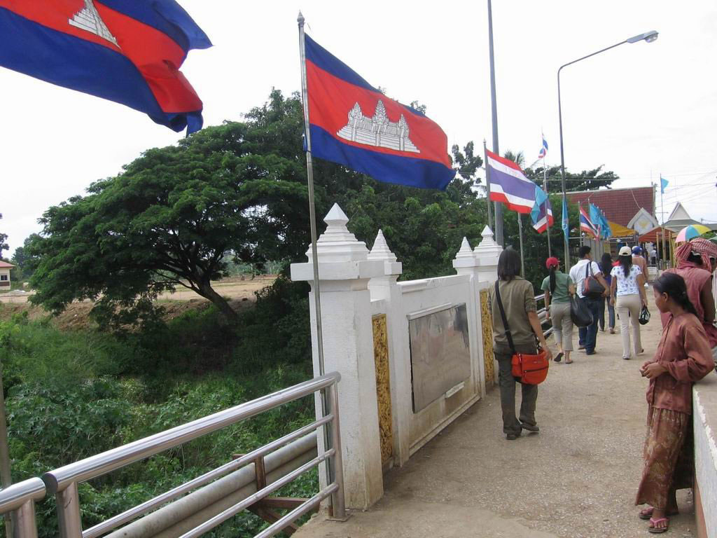 Pedestrians cross the border between Cambodia and Thailand at the Poipet International Bridge.