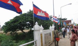 Pedestrians cross the border between Cambodia and Thailand at the Poipet International Bridge.