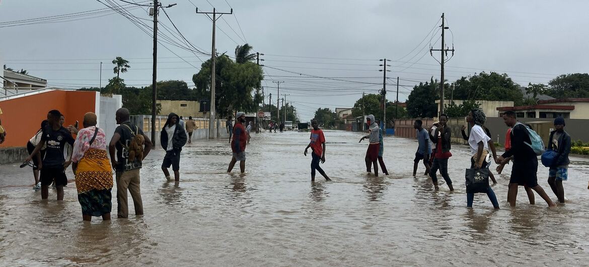 On 19 January 2026, residents walk through a flooded street in Xai Xai, Gaza province, Mozambique, following extreme rainfall caused by climate change.