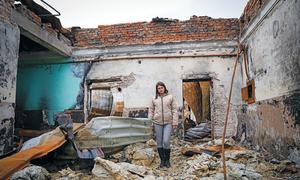 A woman stands in a bombed-out building in Pokrovsk Town in the Donetsk region of Ukraine.