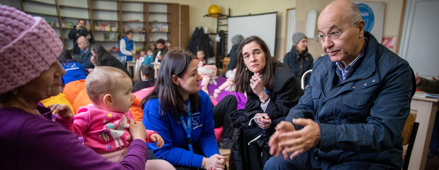 UN High Commissioner for Refugees Barham Salih visits a UNHCR-supported transit centre in Zaporizhzhia, Ukraine, speaking with displaced families including Nina and her granddaughter Milana, who were evacuated from frontline areas.