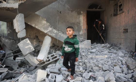 A young boy walks through the rubble of his home in Al Nusirat, Gaza.