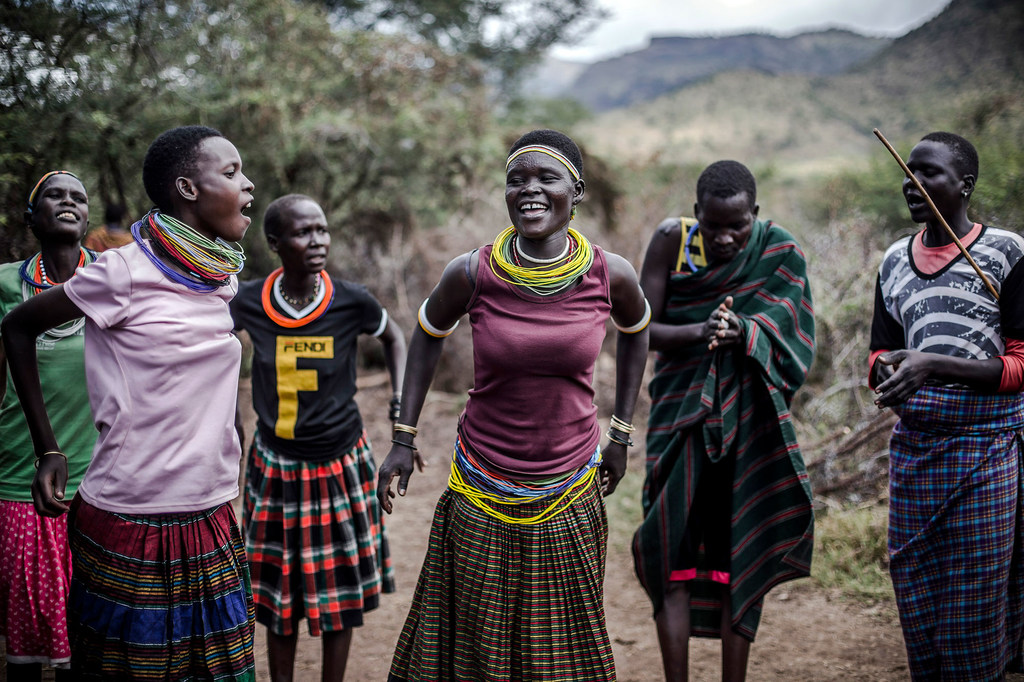 A group of  Karamojong people in Uganda perform songs to share knowledge about weather and animal health.