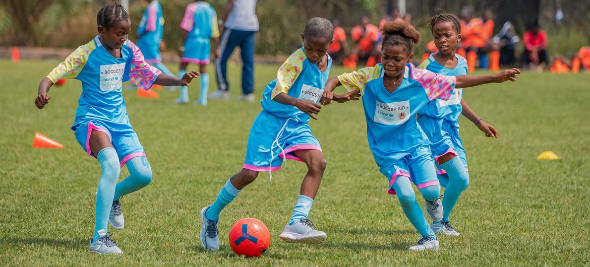 Girls play football at an event in DR Congo.