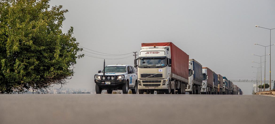 Trucks with humanitarian aid travel from Turkey to the Bab Al-Hawa border crossing in Syria in December 2022.