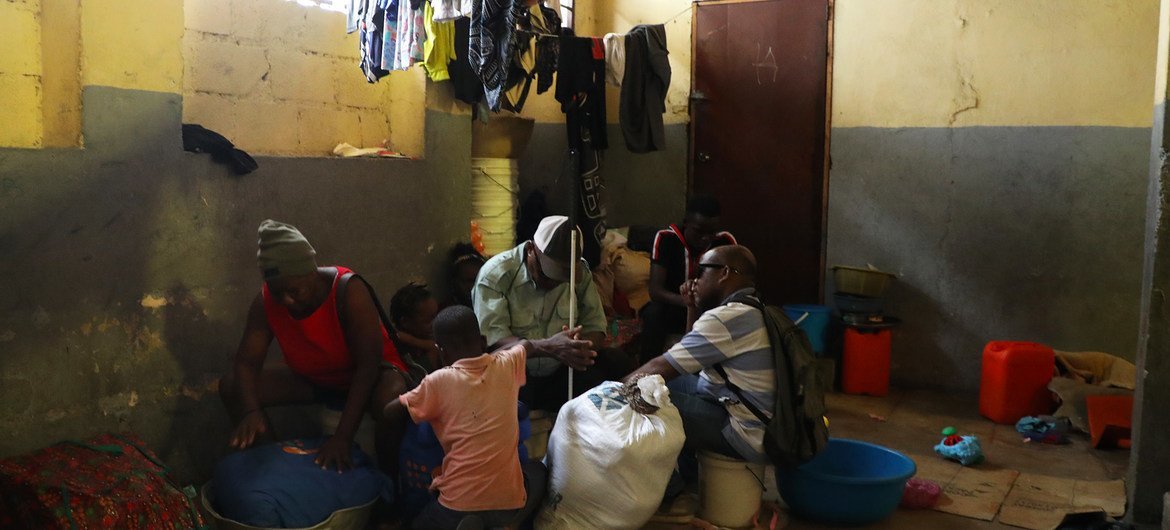 Samuel (centre) and his family wait to leave a temporary site for internally displaced people in Port-au-Prince.