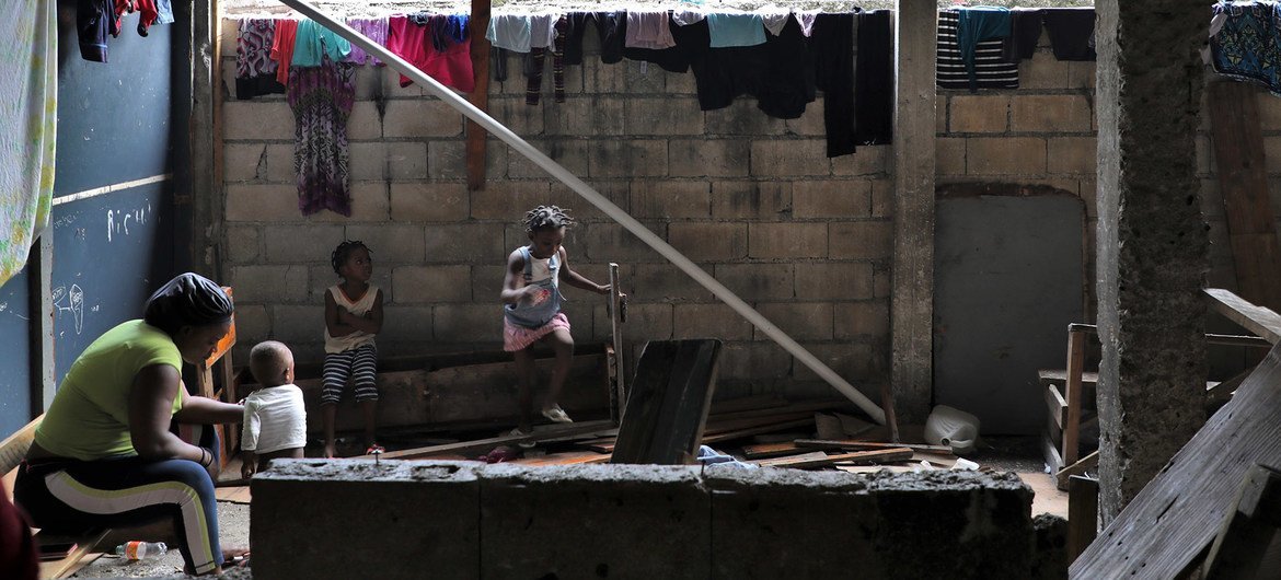 Families displaced by gang violence in the Haitian capital Port-au-Prince live in a school before being relocated by the UN.