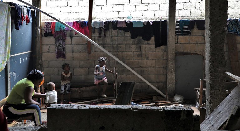 Families displaced by gang violence in the Haitian capital Port-au-Prince live in a school before being relocated by the UN.