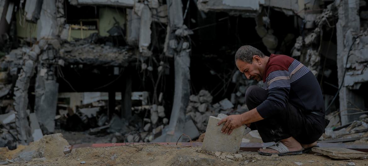 A man searches through the rubble of his destroyed house in Sheikh Zayed City in the north of the Gaza Strip.