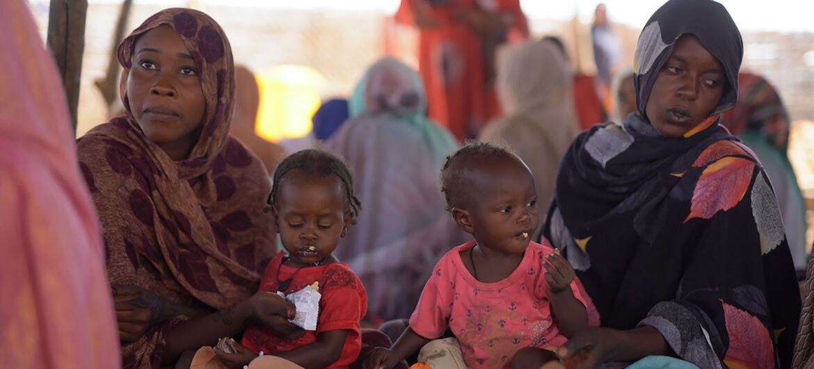 Mothers feed their children with ready-to-use-therapeutic food (RUTF) at a UNICEF-supported nutrition center in Tawila, North Darfur, Sudan, as part of a campaign to screen and treat malnutrition among children under five.