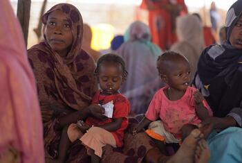 Mothers feed their children with ready-to-use-therapeutic food (RUTF) at a UNICEF-supported nutrition center in Tawila, North Darfur, Sudan, as part of a campaign to screen and treat malnutrition among children under five.