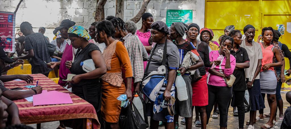 Aid is distributed by the World Food Programme in a downtown neighbourhood of Port-au-Prince.