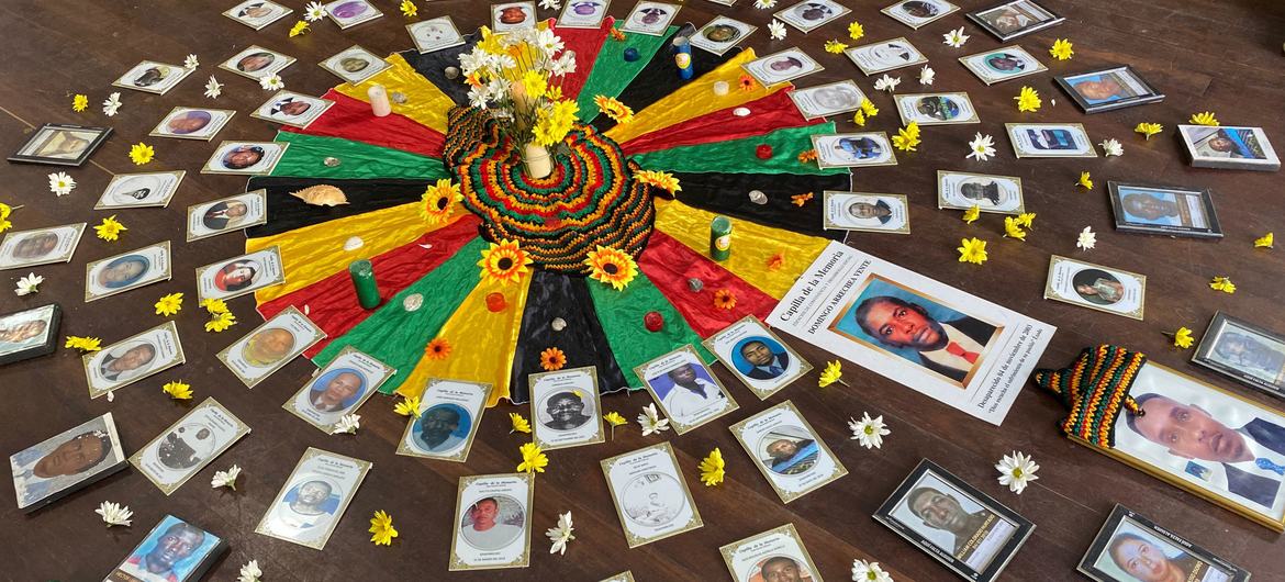 A tribute to victims of the conflict in Colombia is displayed on the floor of a building.