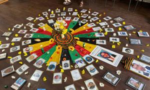 A tribute to victims of the conflict in Colombia is displayed on the floor of a building.