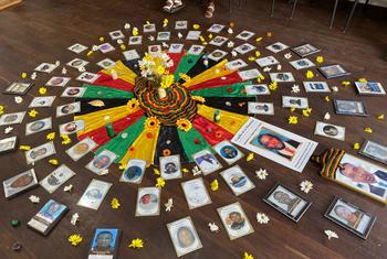 A tribute to victims of the conflict in Colombia is displayed on the floor of a building.