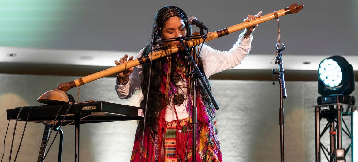 Brisa Flow playing a traditional instrument at the Stand Up for Social Justice concert in Geneva in February 2025.