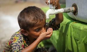 A 5-year-old boy drinks water from a waterpoint installed by UNICEF at a temporary camp in Larkana District, Sindh Province, Pakistan.