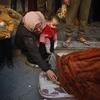 Palestinos identifican a sus seres queridos muertos en los ataques aéreos del 18 de marzo.