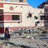 A woman and child walk through the heavily bombed town of Khuza’a in the Gaza Strip.
