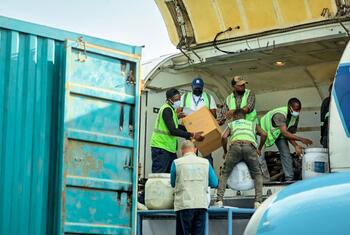 Workers unload boxes and containers from a cargo plane at Bunia airport during the Ebola response in DR Congo.