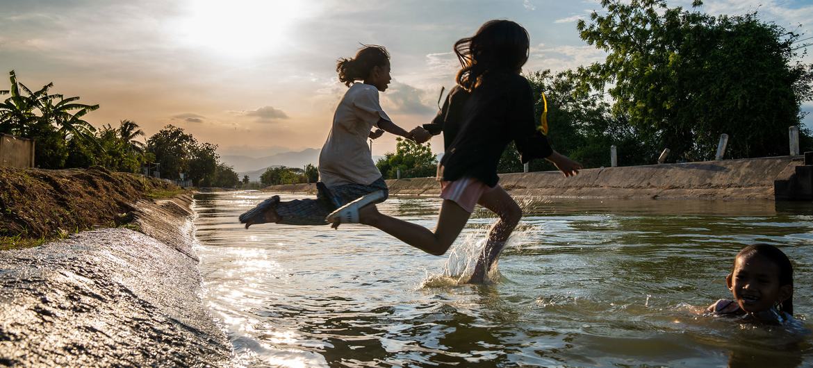 Children jump into a canal in central Viet Nam.